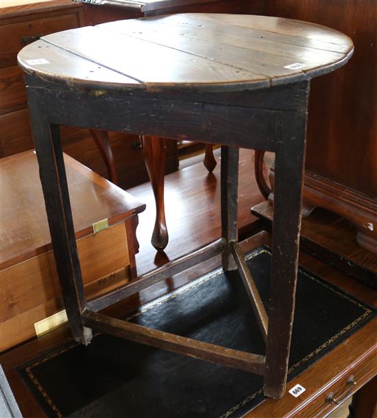 An 18th century oak circular topped cricket table